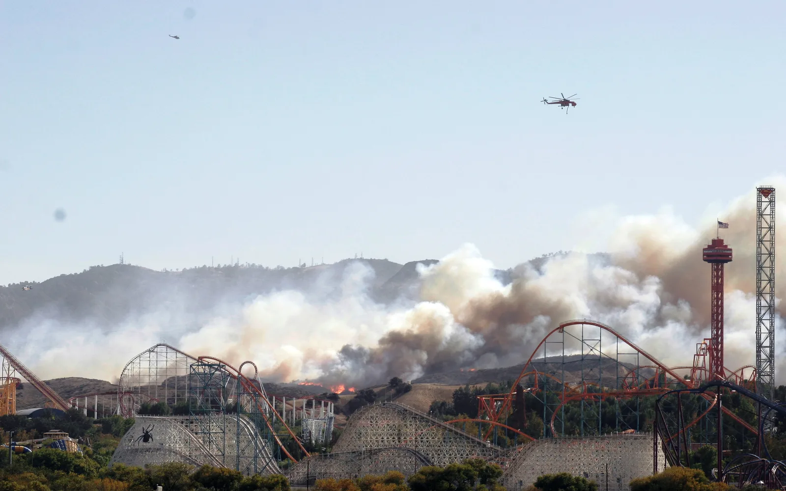 Six Flags Magic Mountain amusement park with Wildfire roller coaster visible against clear sky